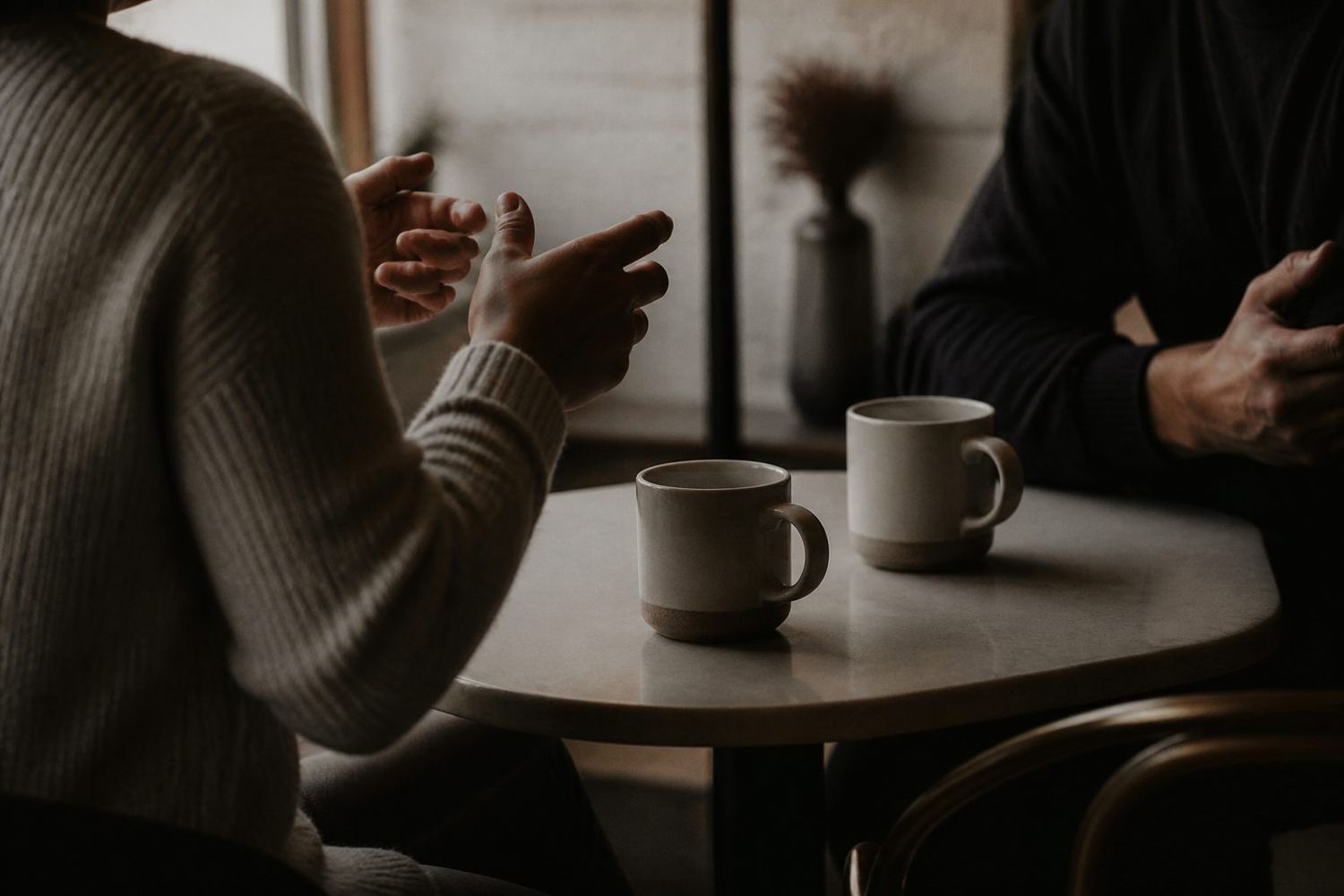 Two people talking across a table